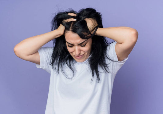 A young woman examining her hair loss caused by stress, representing female hair loss and stress. women’s hair care solutions, stress-induced hair thinning, keratin fiber hair concealer, female hair restoration tips, instant hair volume booster