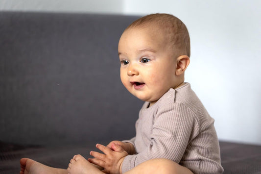A baby with a visible scalp during early hair loss stage, illustrating natural regrowth and the importance of nutrient food for hair growth. baby scalp care, infant hair growth, baby hair regrowth