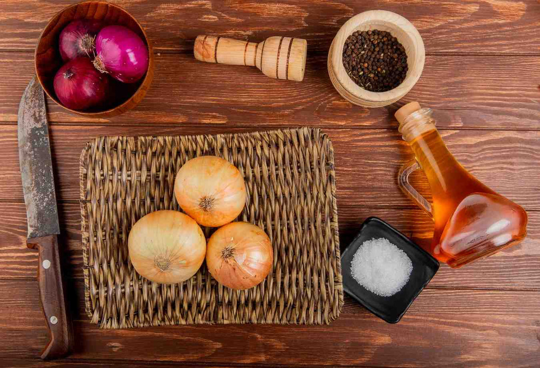 oil on a wooden surface representing natural hair care oil ingredients used in onion-based hair growth essential oil treatments. natural onion hair oil, herbal hair growth remedy, scalp nourishing oil, hair strengthening treatment, DIY hair care recipe