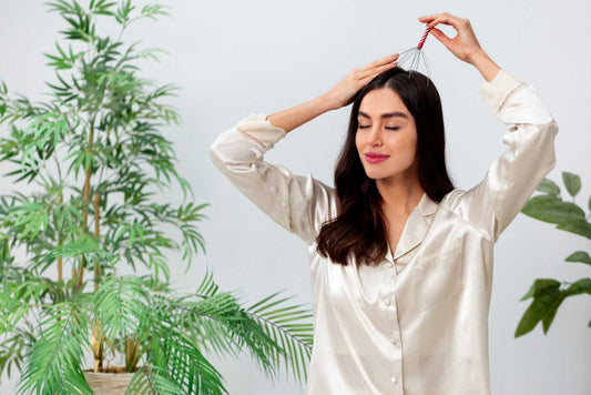 A woman massaging her scalp with a head massager, symbolizing self-care and effective use of hair-growth serums. best serums for hair growth, scalp massage benefits, hair thinning care, biotin hair routine, healthy hair nutrition