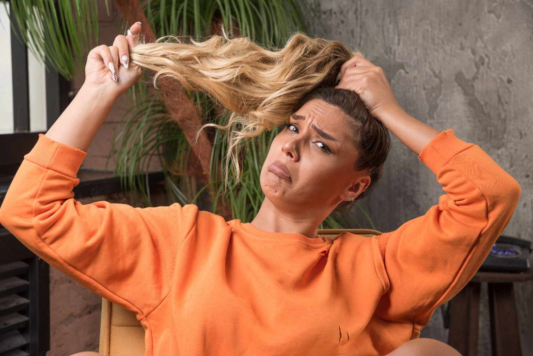 looking worried while examining her tangled hair, representing hair loss yoga, PRP therapy. PRP hair treatment, yoga for hair growth, natural hair regrowth, hair density improvement